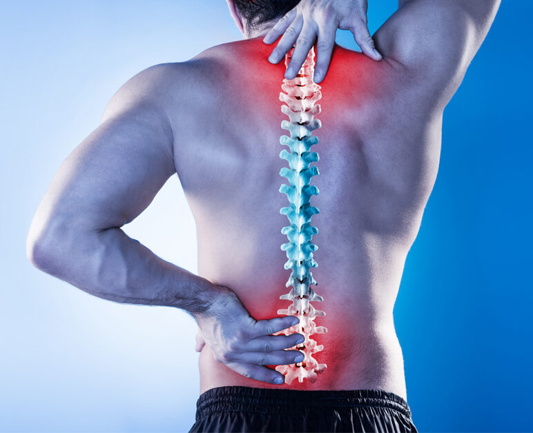 Physiotherapist assessing patient with lower back pain